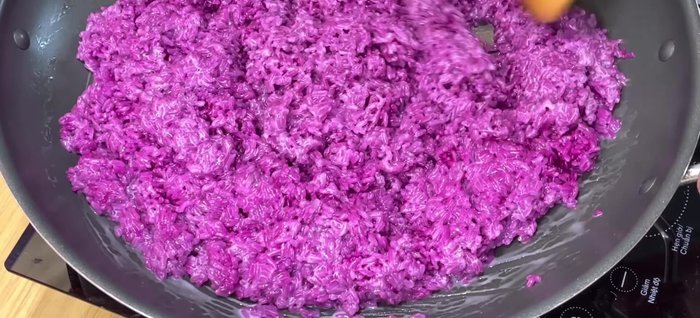 Stir-fry the sticky rice and coconut milk mixture over low heat for 13-15 minutes, stirring frequently, until it becomes a smooth, soft mass. Be careful not to crush the rice grains.