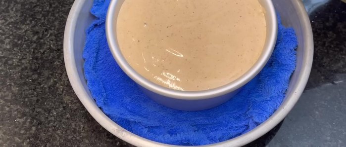 Bake in a water bath: Place the mold in a larger baking tray lined with a towel. Pour boiling water into the tray until it reaches halfway up the sides of the mold. Bake at 155°C for 60 minutes. Let cool in the oven for 5 minutes before removing.