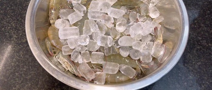 Peel and devein the shrimp, leaving the tail and last segment intact. Keep shrimp chilled in ice water.