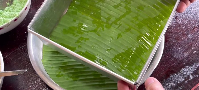 Grease the mold and line it with banana leaves (optional). (393.199)