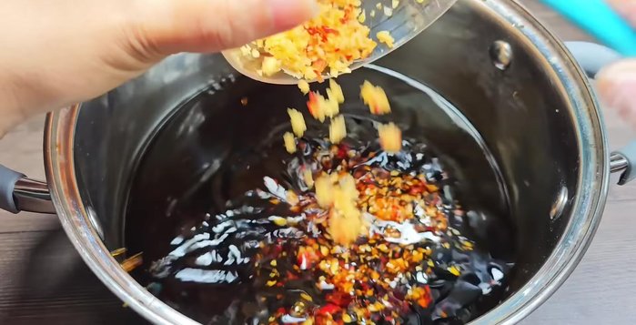 Once the soy sauce mixture is cool, add the minced garlic and chili. Mix well.