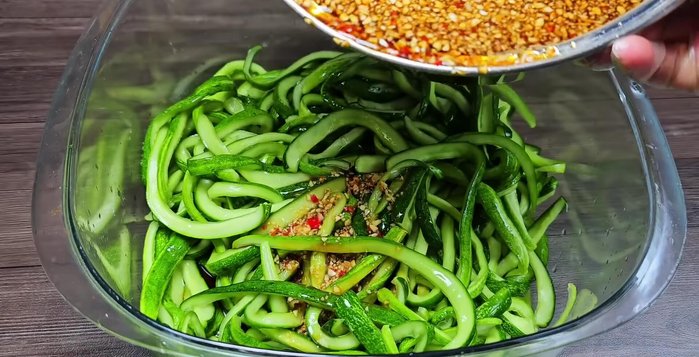 Add the drained cucumbers to the cooled soy sauce mixture. Toss gently to coat evenly.