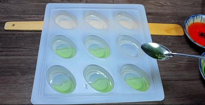 Pour each color quickly, working swiftly before it solidifies. Tilt the mold to help create a visually appealing gradient.