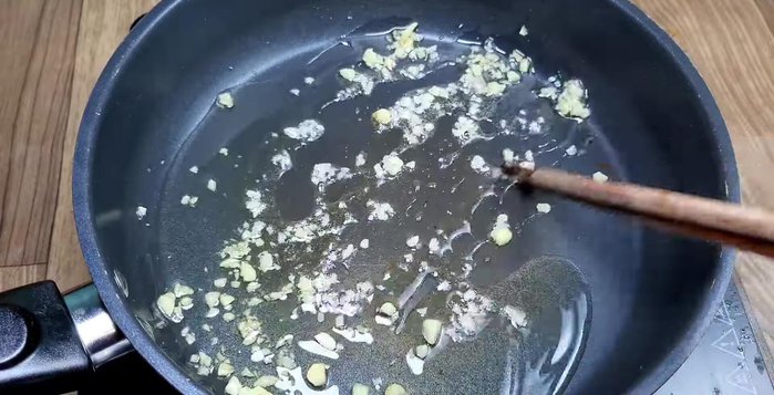 Sauté minced garlic in a pan. Add the sour cabbage, the remaining 1 tbsp of sugar, and ½ tsp MSG. Stir-fry until the cabbage absorbs the spices.