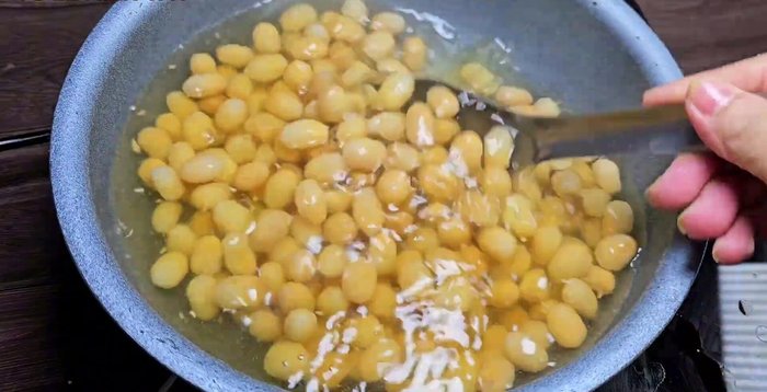 Blanch the pulp in boiling water twice, for approximately 5 minutes each time. Rub the pulp after each blanch to remove the bitter core. Discard the boiling water.
