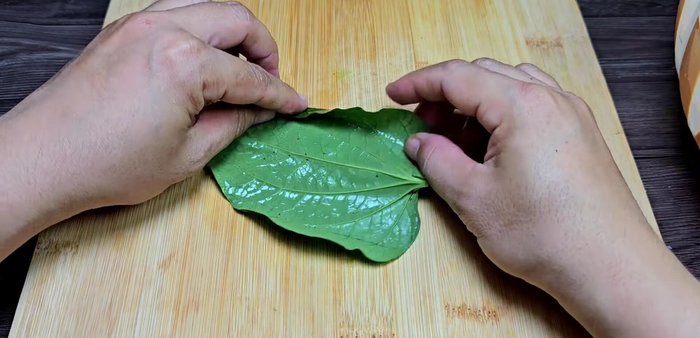 Wrap the pork mixture in lolot leaves, shiny side out. Arrange leaves neatly for a nicer presentation.