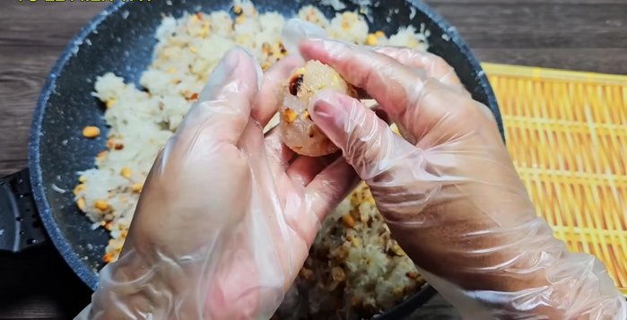 Assemble the cakes: Take approximately 100g of the sticky rice batter and flatten it. Place 40g of filling in the center, wrap with banana leaves.