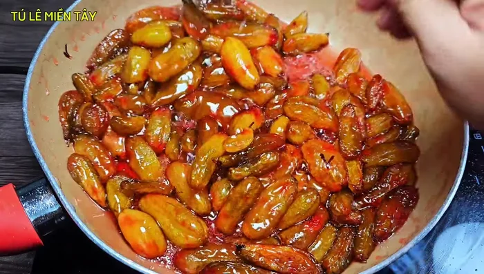 Simmer until the sugar water thickens and there is little water left. Avoid overcooking to prevent burning.