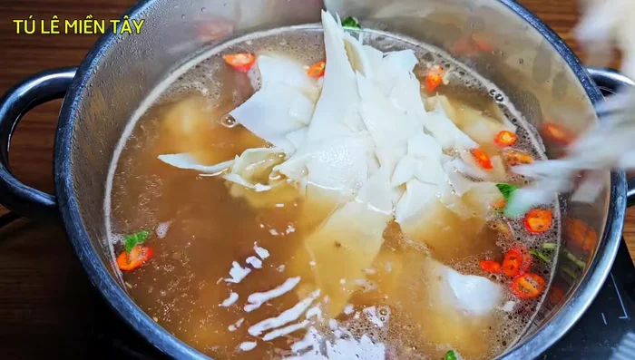 Add bamboo shoots and tomatoes: Add the prepared bamboo shoots and tomatoes to the soup. Continue cooking until the fish is cooked through.
