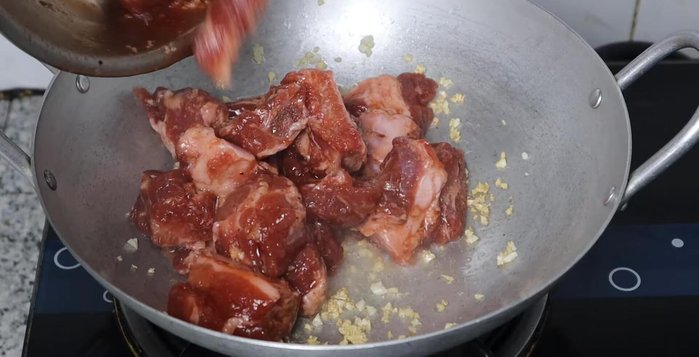 Add marinated ribs to the pan. Stir-fry until firm and dry.