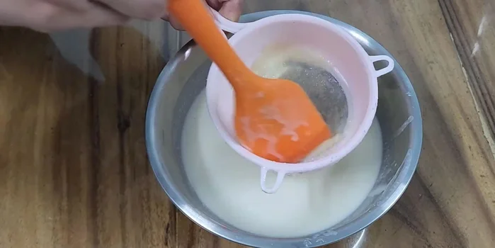 Boil the white dough mixture until cooked.