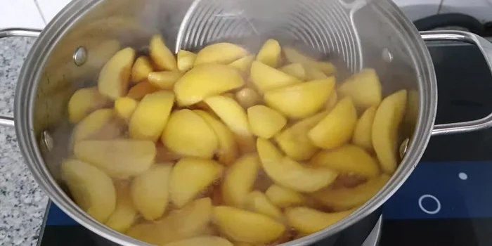 Remove the peaches from the syrup and quickly plunge them into ice water to cool and maintain crispness.