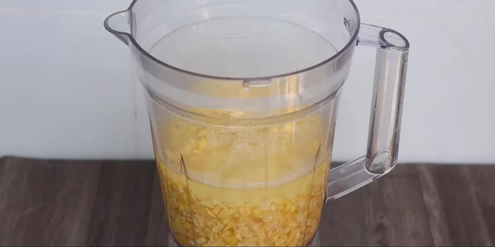 Combine the blended corn with the corn water and grind again until smooth.