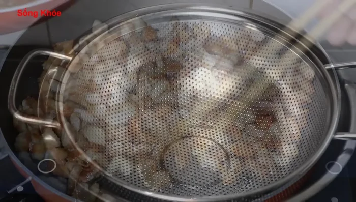 Continue stir-frying until the meat is slightly burnt at the edges. Filter the rendered fat using a wooden block.