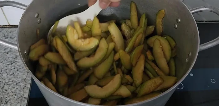 Cook the winter melon with sugar on low heat until it turns purple.