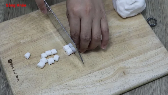 Roll the dough into long strands and cut into small pieces. Roll the pieces into balls.