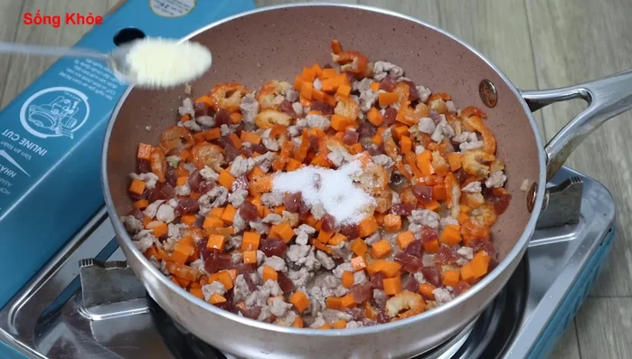 Add sugar, seasoning powder, fish sauce, and pepper. Stir-fry until the filling is dry and the carrots are cooked.