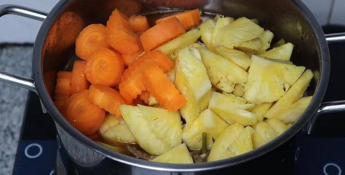 Add pineapple and carrots. Add 700ml of water and another half liter of coconut water.
