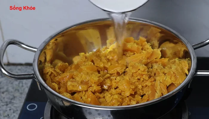 In a pot, combine half a cup (150ml) of coconut water and the sugar. Stir initially until the sugar dissolves.