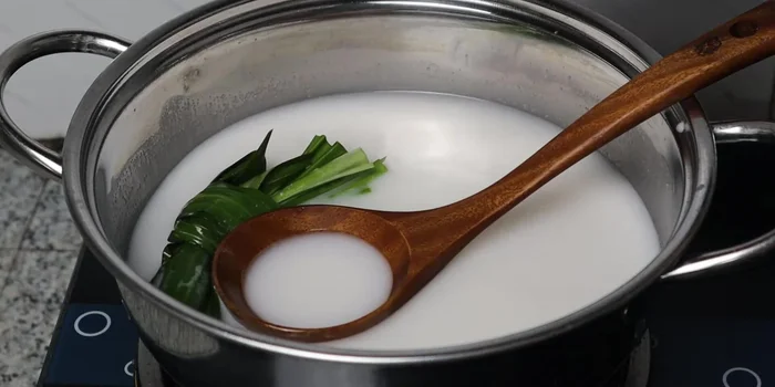 Add the cooked taro strands to the coconut milk mixture and simmer.