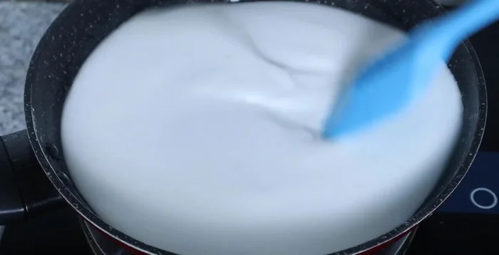 Cook the dough over low heat, stirring constantly until it sets and becomes a soft mass. Turn off heat and continue stirring until it cools slightly.