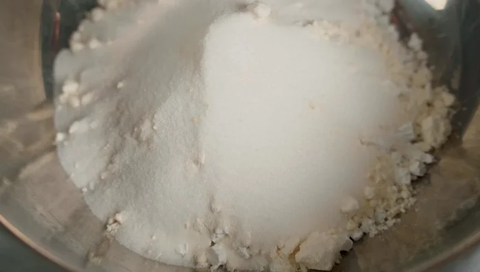 Add sugar and turmeric powder to the flour mixture.