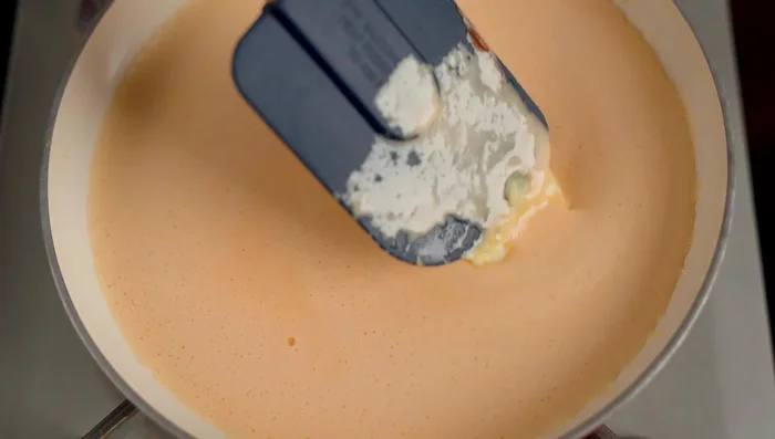 Cook the salted egg mixture in a pan over low heat with butter until slightly boiling.