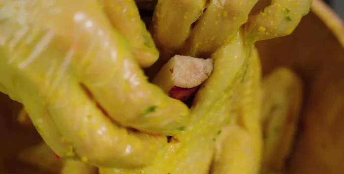 Stuff the chicken: Stuff some sugarcane and lemongrass into the chicken's belly.