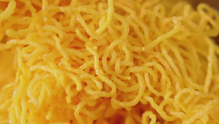 Fry noodles: Heat oil to 180°C. Fry noodles until puffed and crispy. Drain and set aside.