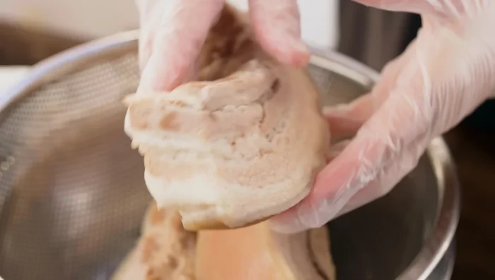 Dry the meat using a fan or kitchen paper. Place the cooled pork in a clean, dry jar. Pour the cooled fish sauce mixture over the meat, ensuring it's fully submerged.
