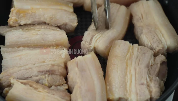Pan-fry the marinated pork belly until slightly golden brown.