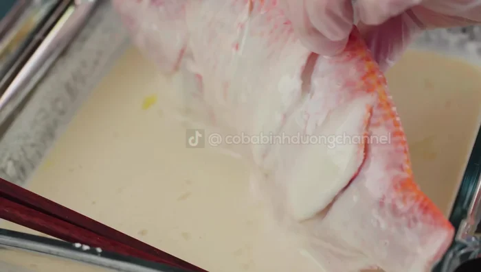 Coat the fish evenly with the flour mixture, ensuring the gills, belly, and slits are covered.