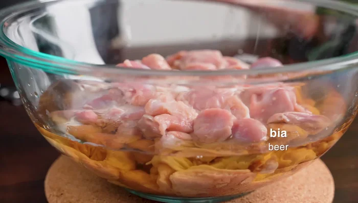 Marinate chicken gizzards in beer for 10-15 minutes, ensuring even coverage.