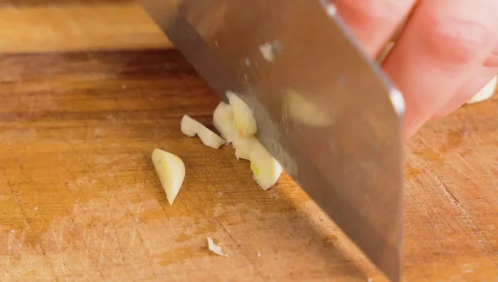 Finely chop garlic, ginger, and green onions.
