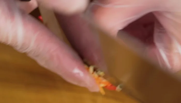 Prepare chili peppers and herbs for garnish.