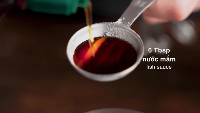 Prepare the salad dressing: Mix sugar, fish sauce, and lemon juice in a bowl.