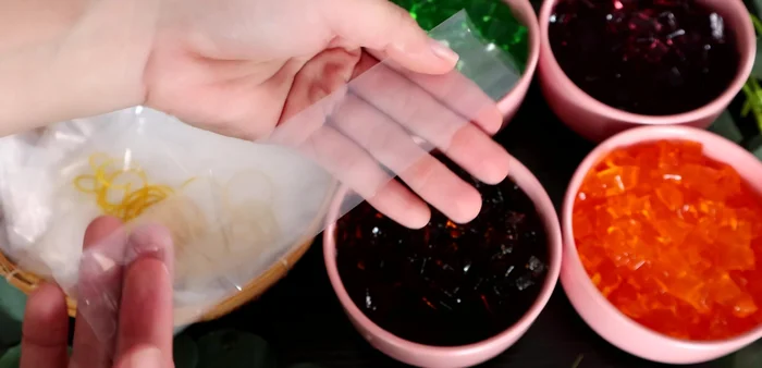 Layer jelly pieces into plastic bags.