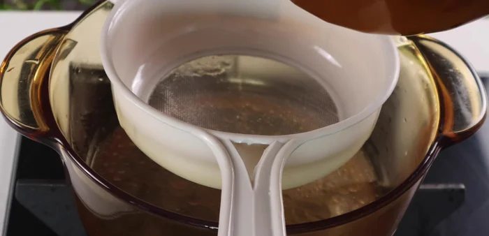 Strain the bone broth, reserving about 2 liters. Add another half liter of water, sugar, MSG, and seasoning powder.