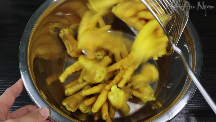Mix boiled chicken feet with fried onions, garlic, seasoning, sugar, and pepper.