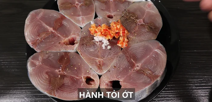 Marinate the tuna with salt, pepper, and the chopped garlic, shallots, and chili for 5 minutes.