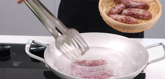 Add the sausage to the boiling water.
