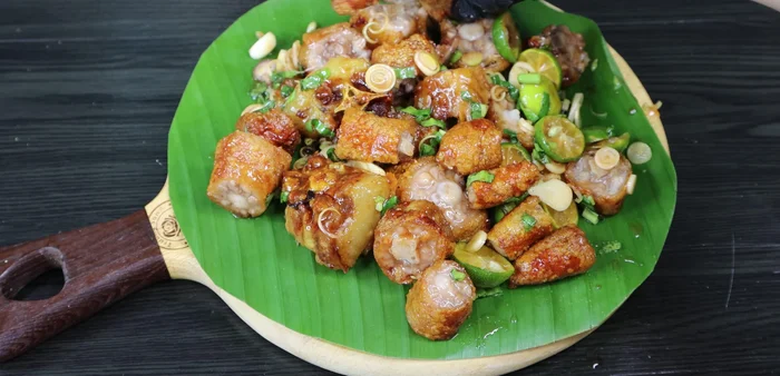 Serve and garnish with fresh chilies.
