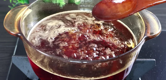 Once the fish sauce has simmered for an hour and cooled slightly, skim off any foam.