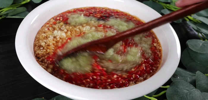 Once cooled, add the minced garlic, chopped chili, and lemon juice. Stir well.