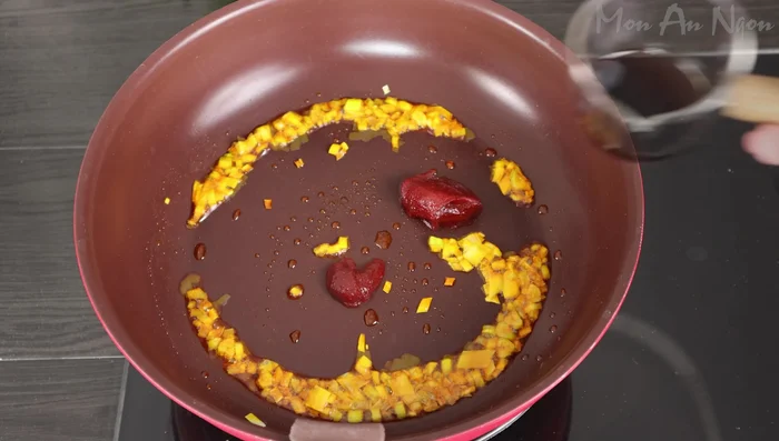 Add 1 tablespoon each of Korean chili sauce, soy sauce, and sugar; 1/2 tablespoon of seasoning powder, and 1 tablespoon of Vietnamese chili sauce to the pan.