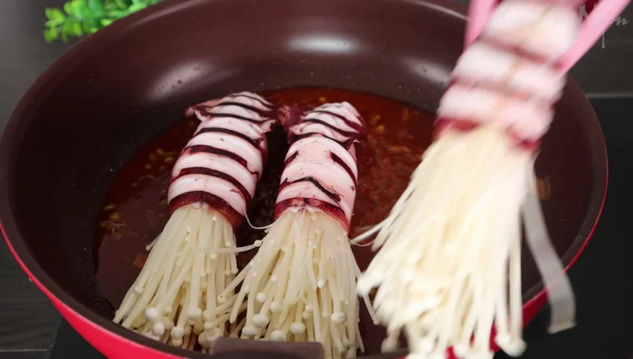 Add the stuffed squid and mushrooms to the sauce. Simmer for about 3 minutes until the mushrooms are cooked.