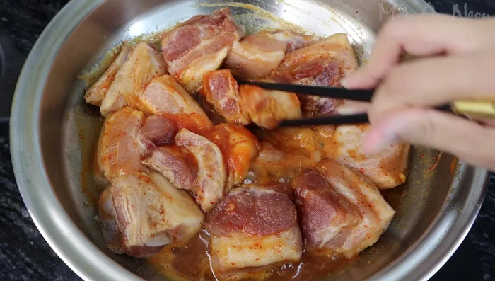 Bring a pot of water to a boil, add the marinated pork belly, and simmer.