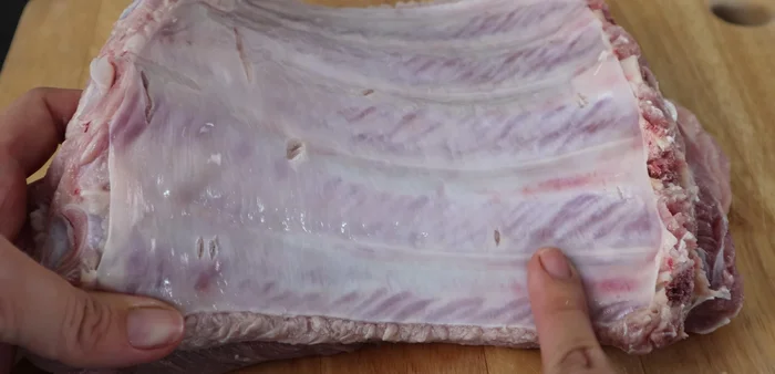 Peel off the thin layer of skin from the underside of the ribs to prevent toughness.