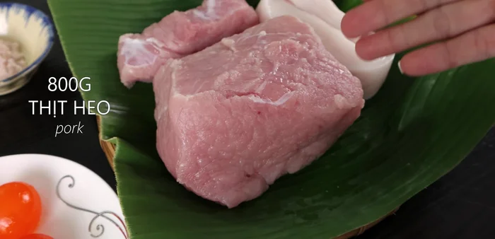 Prepare the ingredients: salted eggs, pork (lean and belly), sugar, salt, pepper, fried onions and garlic, Mai Que Lo wine, and a green incubator tube.
