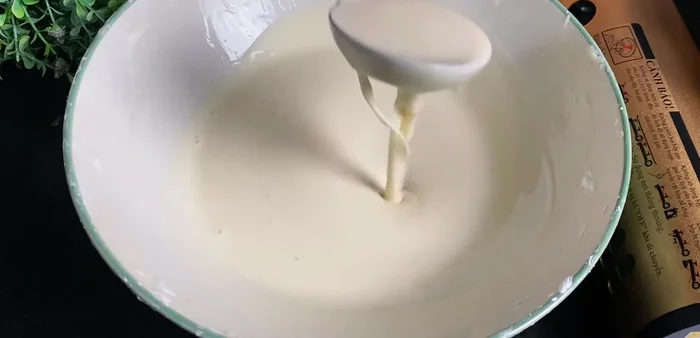 Fry the cakes: Using a measuring cup, scoop the dough and carefully drop it into the hot oil. Pour the dough in the center and lift the cup slightly to help create a high peak. Rotate the cake for even browning.